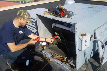 Here you see one of our professional HVAC technicians troubleshooting an HVAC/R unit to provide proper maintenance.
